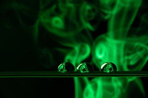 Three water drops with green smoke
