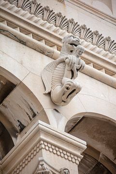 Statue of dragon holding man at Cathedral of St. Domnius in center of Split in Croatia by Joost Adriaanse