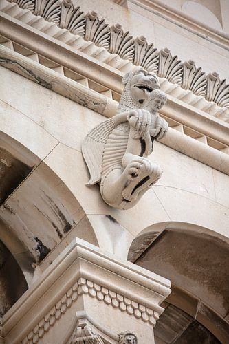 Statue of dragon holding man at Cathedral of St. Domnius in center of Split in Croatia