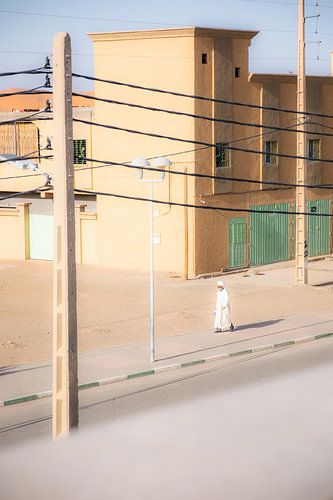 Arab man walks through desert town of Merzouga