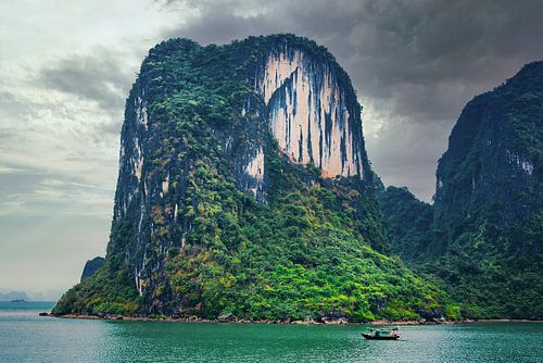 Impressive rock in Halong Bay with fishing boat, Vietnam