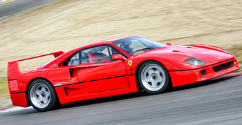 Ferrari F40 driving through a corner at a race track