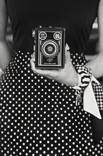 Woman in dress with old camera