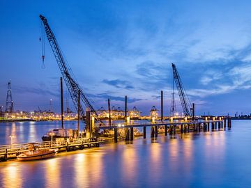 Illuminated pier with large cranes at twilight_2 by Tony Vingerhoets