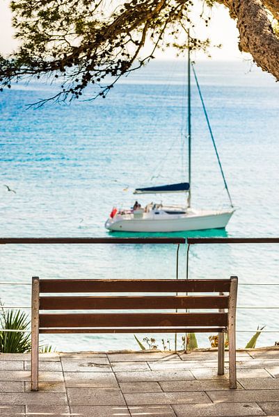 Idyllic view of sailboat anchored at bay coast by Alex Winter