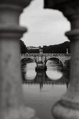 Bridge in rome seen through the pillars of the Ponte Vittorio Emanuele II