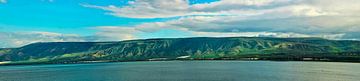 Golan Heights and Tiberian Lake panorama where green hills, blue sky with clouds and the surface of  by Michael Semenov