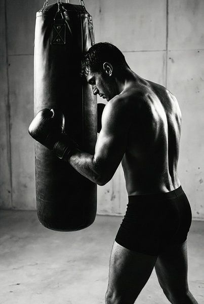 Man with Boxing Gloves Hitting Punching Bag, Black and White by Markus Gann