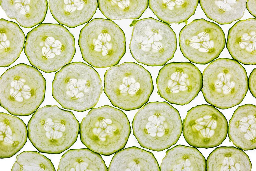 Cucumber slices on a white background by Carola Schellekens
