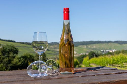 Wine bottle and wine glasses on a wooden table