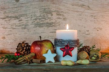 Advent and Christmas decoration with candle, ornament and food by Alex Winter