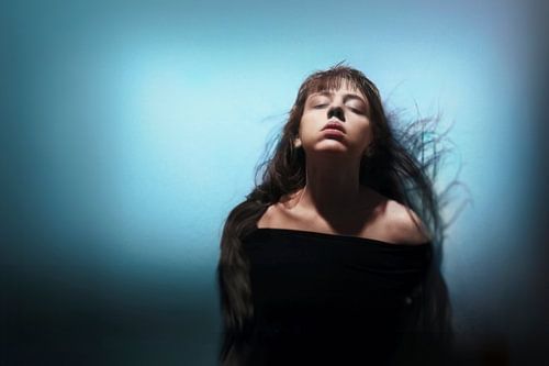 Betoverende Fotografie: Vrouw in Sereniteit Tegen Cyaan Achtergrond | Innerlijke Rust en Harmonie