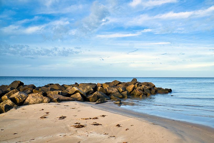 Stone groyne juts into the sea on a sandy beach in Denmark by Martin Köbsch