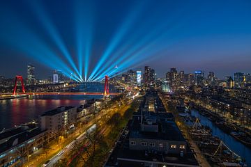 The skyline of Rotterdam with light show for 150 years of Holland America Line
