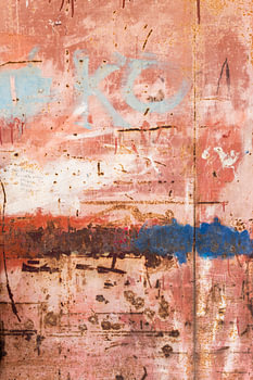 Détail d'une porte rose rouillée d'un atelier