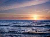 Surfers in the sea during sunset. by Sjoerd van der Hucht thumbnail