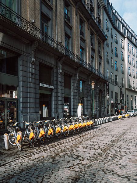 Yellow bikes in the centre of Brussels in Belgium by Michiel Dros