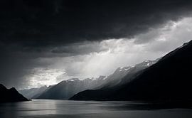 Rain clouds over fjord by Jesse Meijers