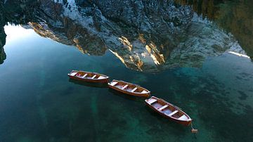 Rowing boats with reflection in the waters of Lago di Braies by Ewold Kooistra
