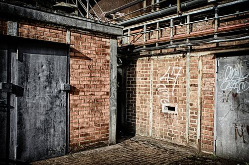 Deel van muren en stalen deuren verlaten fabriek