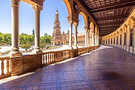 Colonnade with a view of the Plaza de España tower by Easycopters