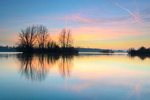 Sunset over a lake with small islands at the end of a winter day