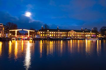 Amsterdam illuminated bridges at the Amstel river during winter