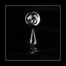 Abstract image of a falling water drop. Black background. by Andie Daleboudt thumbnail