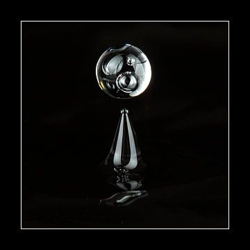 Abstract image of a falling water drop. Black background. by Andie Daleboudt