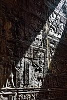 A wall with hieroglyphics in the sunlight
