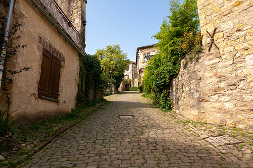 Cobblestone lane between old stone houses in a French village