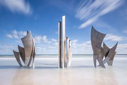 Monument Les Braves in the sea at Omaha Beach Normandy France
