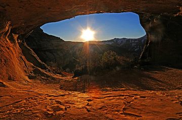 Golden sunset illuminating sandstone cave arch