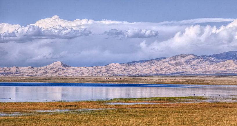 Qinghai lake with mountains, blue sky and impressive clouds by Tony Vingerhoets