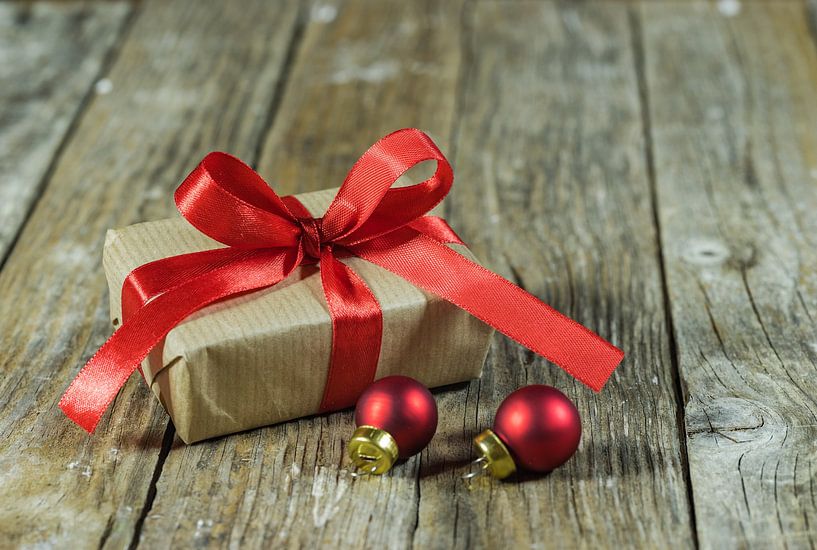 Christmas present with red bauble ornaments by Alex Winter