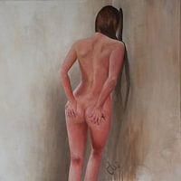 Female nude model posing against a wall.
