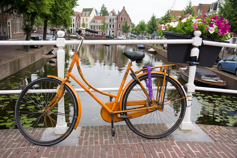 Orange bike on bridge Rapenburg Leiden by Carel van der Lippe