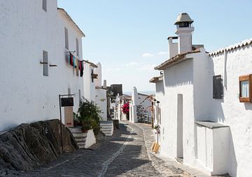 old street with typical white houses in portugal  