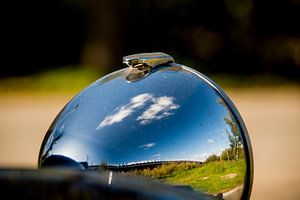 Clouds in the headlight of a Lemon 2cv by Frank Hensen
