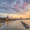 The Düsseldorf skyline with a ship on the Rhine at sunset by Michael Valjak