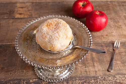 Atmospheric plate of apple globe on an etagere by Henny Brouwers