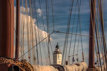 See-through view of Harlingen lighthouse between two masts. by Harrie Muis