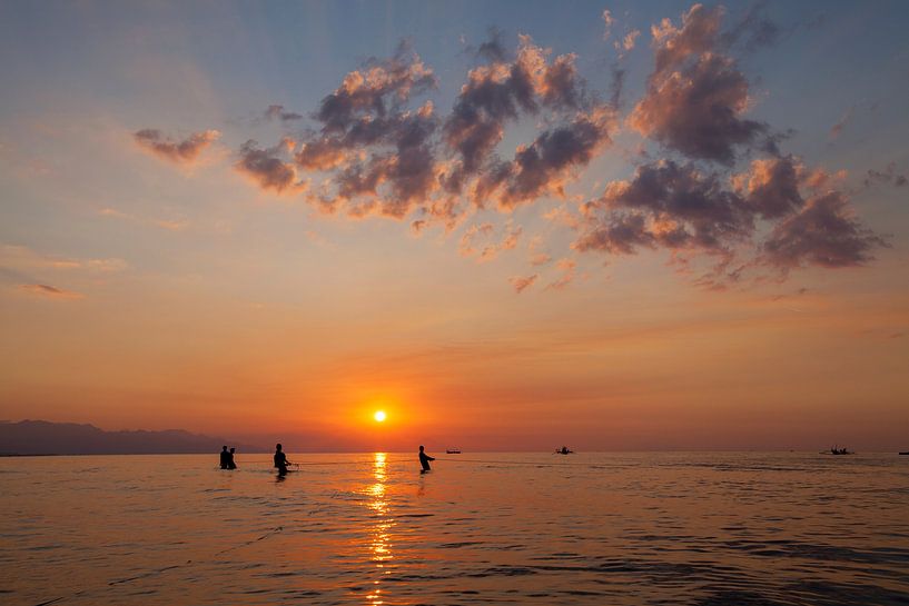 Fishermen silhouette on the beach at colorful sunset in Bali, Indonesia by Tjeerd Kruse