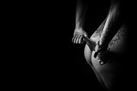 Naked woman with tattoos pulls off thong - sensual black and white art by Retinas images