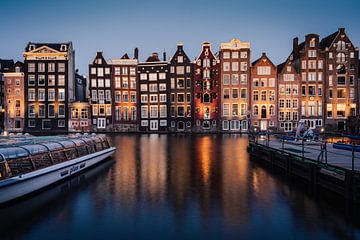 Grachtenpanden aan de Damrak te Amsterdam tijdens het blauwe uur van Thea.Photo