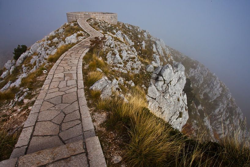 A winding path (road) over a cliff. Everything is in a cloud of fog, a cloud is a road over a hollow by Michael Semenov