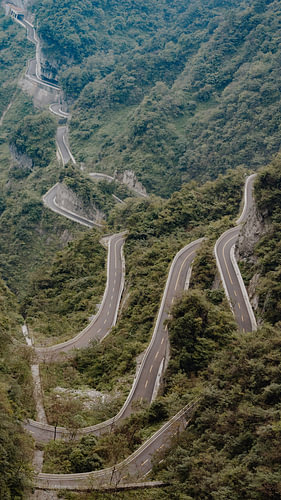 Hairpin bends through a green mountainous landscape