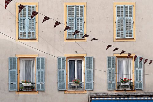 French facade with shutters and flowers