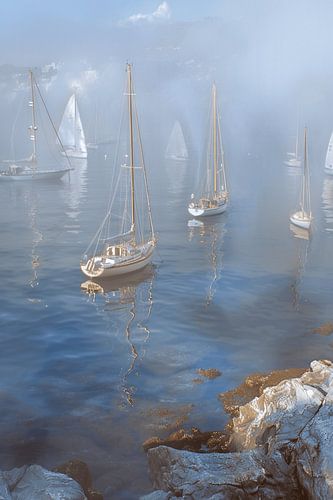 Dreamy summer sea, with moving sailboats and a horizon fading into soft colours
