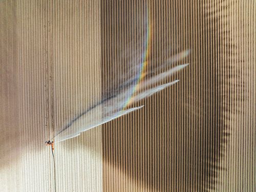 Irrigation pivot gun machine spraying water on a field during a by Sjoerd van der Wal Photography